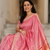 a woman wearing a pink silk linen saree